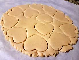 Using cookie-cutter cut the dough Using cookie-cutter cut the dough