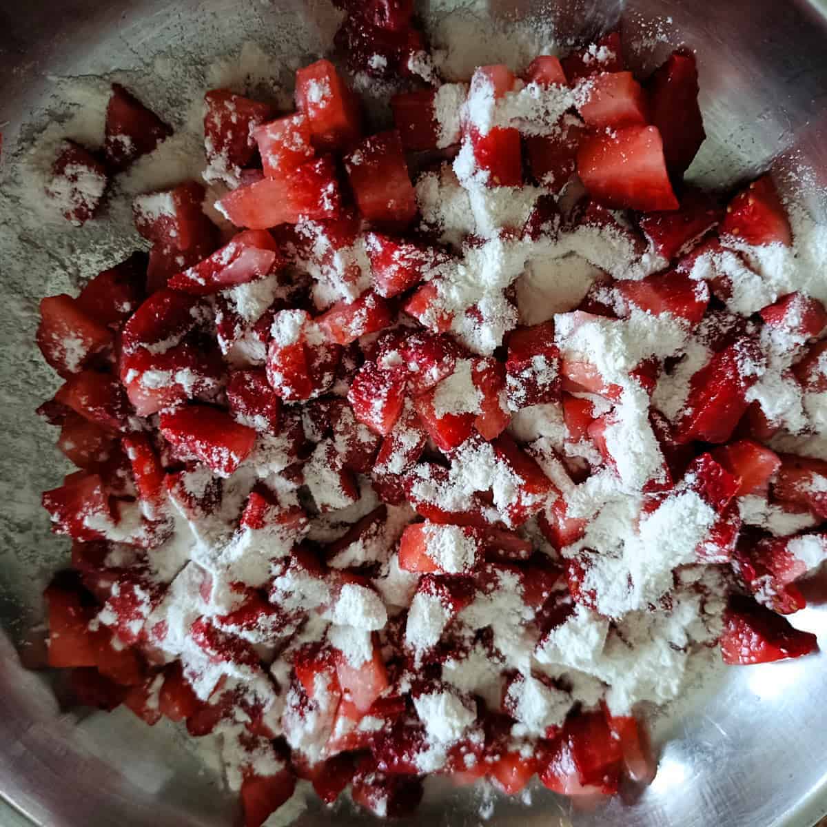 Chopped strawberries coated with flour for strawberry banana muffins