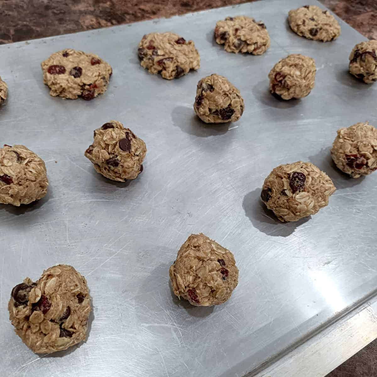 Shape cookies: Dough is scooped onto a baking sheet and lightly flattened before baking.