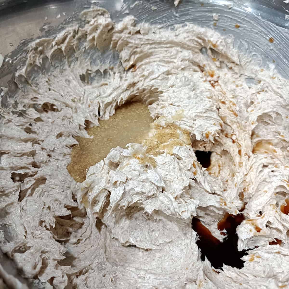 Add flax egg and vanilla: Flax egg and vanilla extract are mixed into the creamed butter mixture until fully combined.