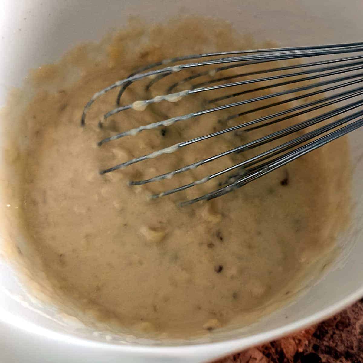 Wet ingredients whisked smooth for strawberry banana muffin batter