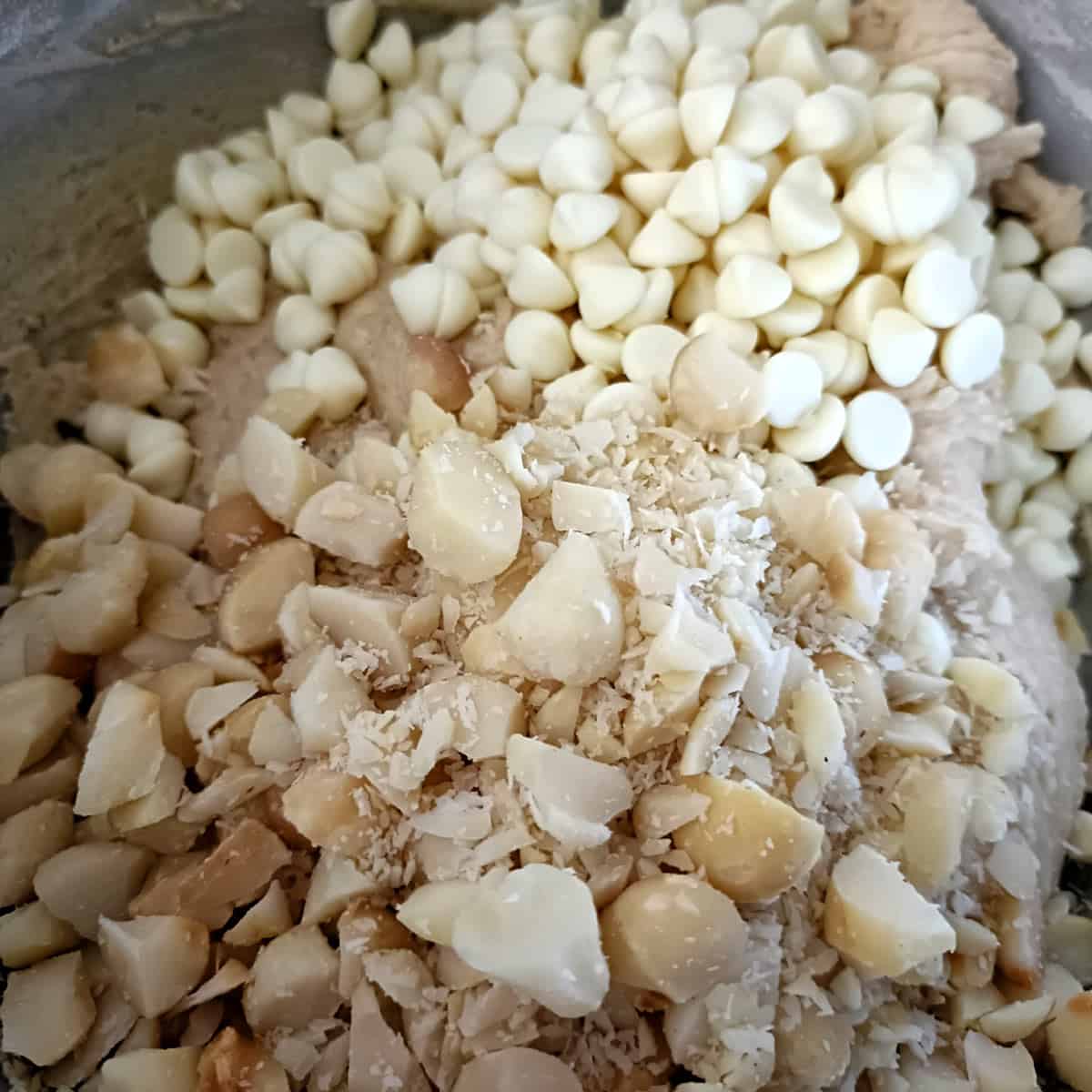 White chocolate chips and chopped macadamia nuts are folded into the dough for texture and richness.