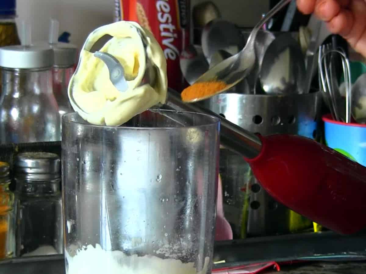 Adding seasoning to eggless mayonnaise and blending again for extra flavor