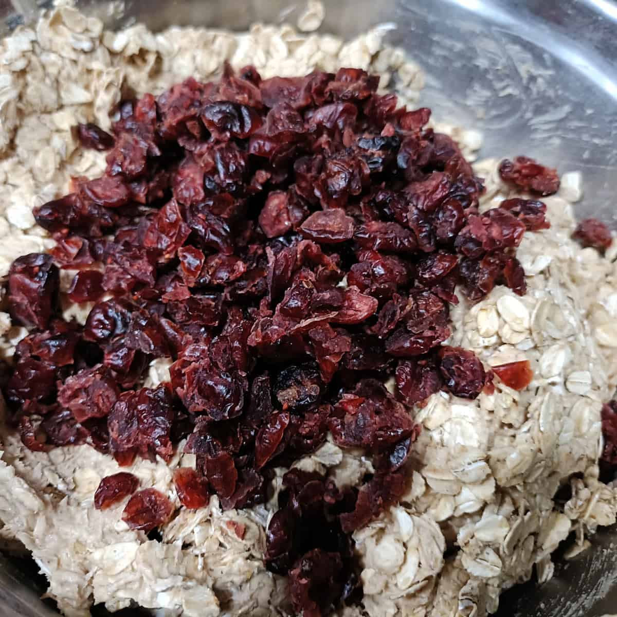 Add raisins and add-ins: Raisins and other optional add-ins are folded gently into the oat cookie dough.