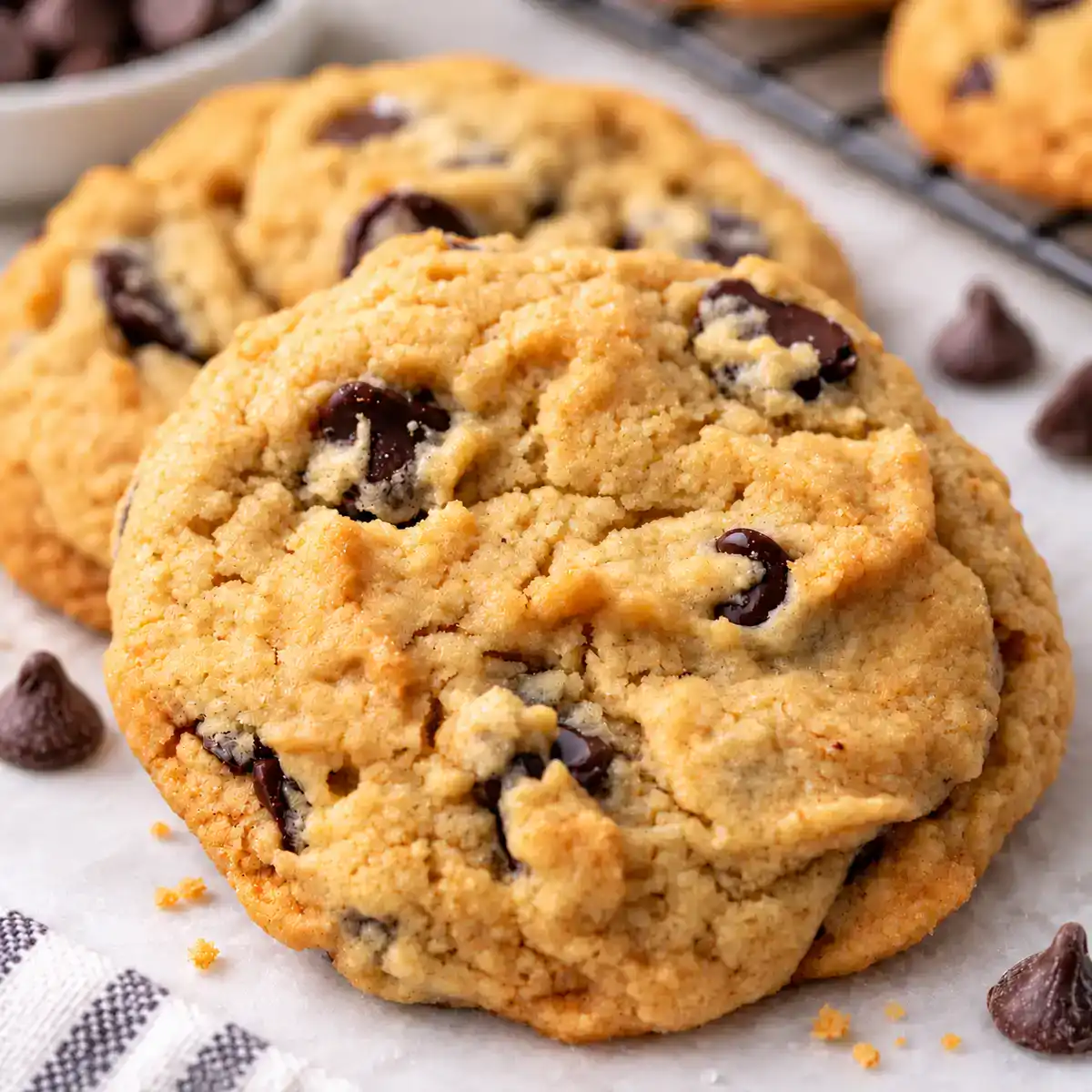 Close-up of thick golden eggless chocolate chip cookies with melted chocolate chips