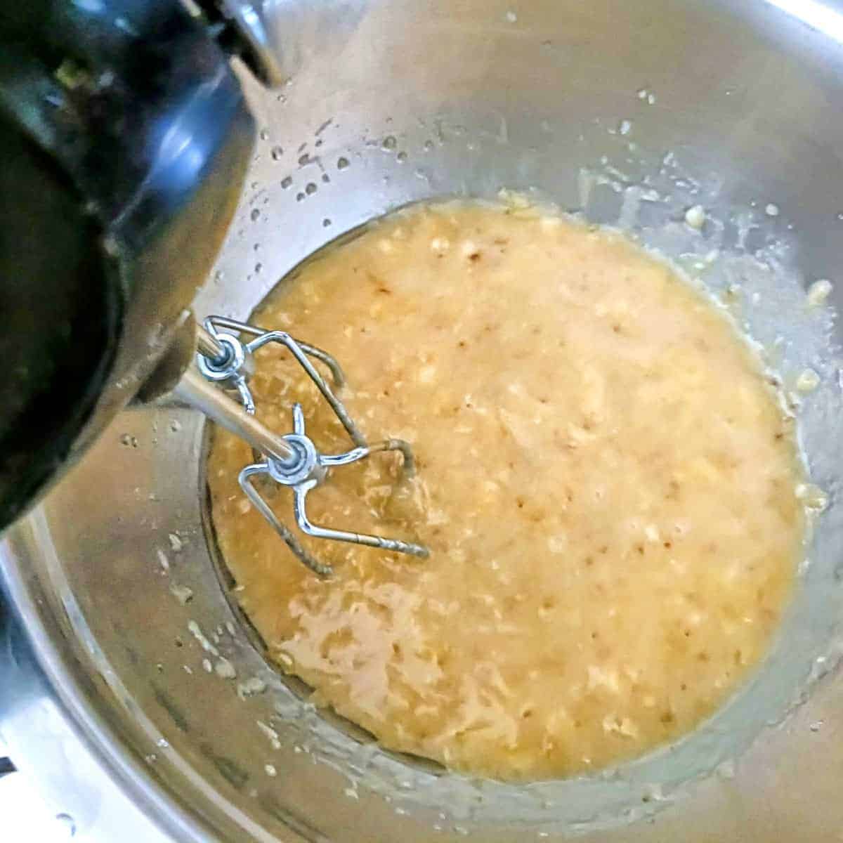 Beating banana mixture with electric mixer until smooth for muffin batter