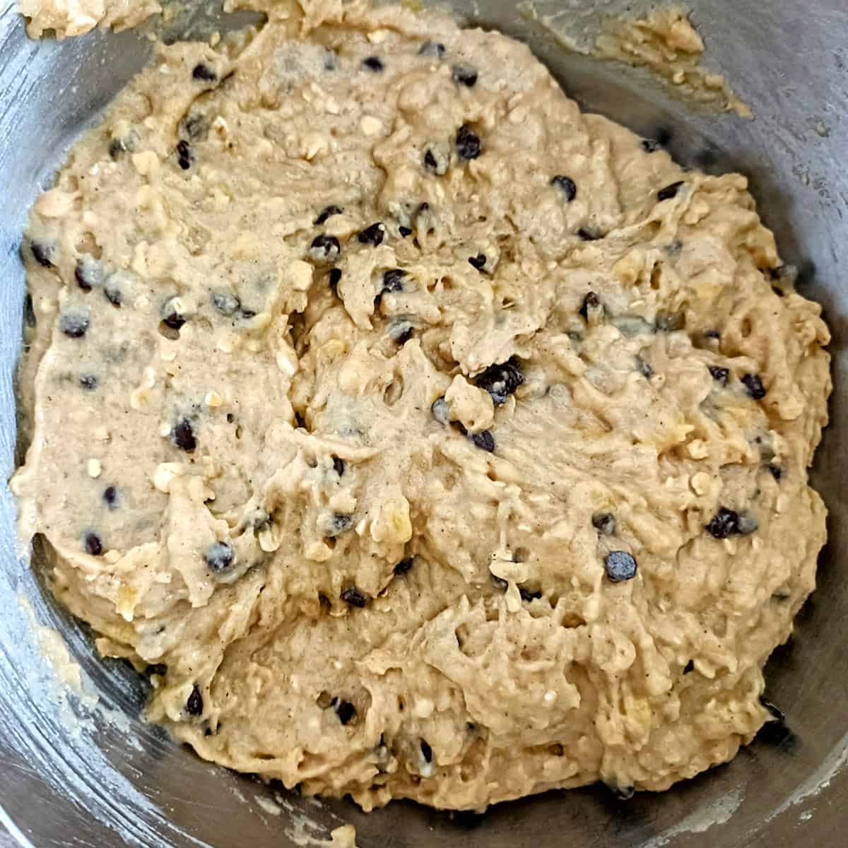 Eggless banana chocolate chip muffin batter fully mixed and ready
