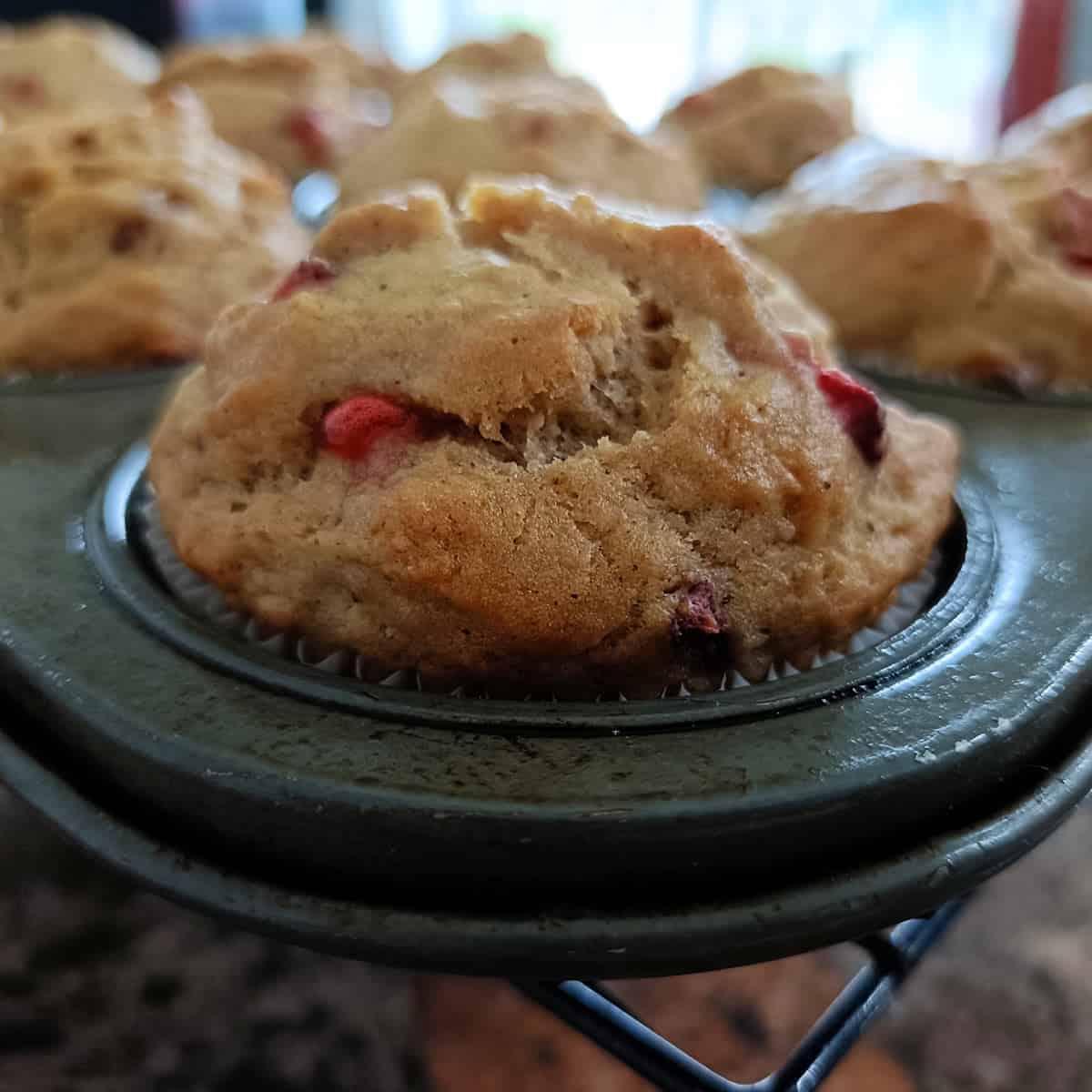 Close-up of moist strawberry banana muffin with fresh strawberry pieces